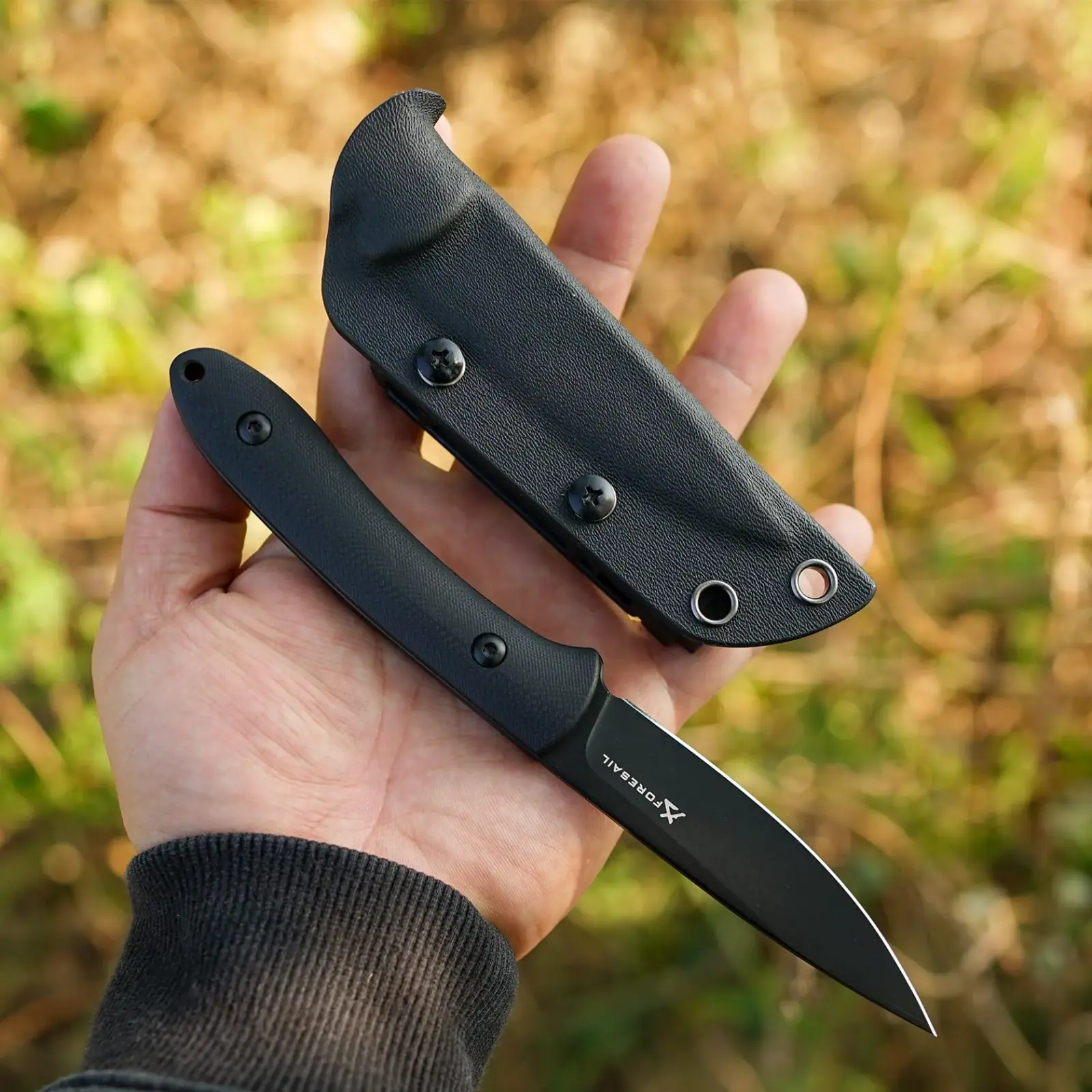 FORESAIL fixed-blade knife and Kydex sheath held outdoors